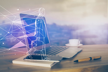 Desktop computer background in office and start up theme hologram drawing. Double exposure. Startup concept.