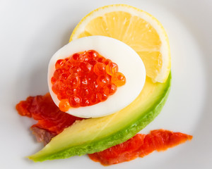 egg with red caviar, chum salmon, lemon, and avocado slices