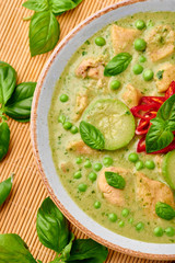 Thai Green Curry with Chicken or Gaeng Kaew Wan Gai in white bowl. Thai Green Curry is a Thailand cuisine dish with green chillies, basil, coconut milk, vegetables and spices. Close up