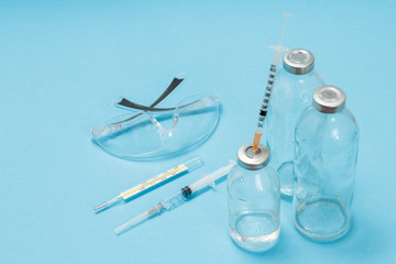 Glasses, a glass mercury thermometer, syringes and bottles for liquid medicine.