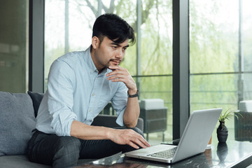 Fototapeta premium A young Asian business man is working