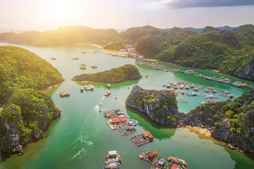 Floating fishing village and rock island in " Lan Ha " Bay, Vietnam, Southeast Asia. UNESCO World Heritage Site. Landscape. Popular landmark, famous destination of Vietnam. Near " Ha Long " bay © Hien Phung