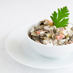 laminaria salad with smoked chum salmon dressed with mayo and decorated with parsley