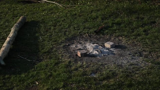 Traces of the extinct bonfire on the ground after tourists