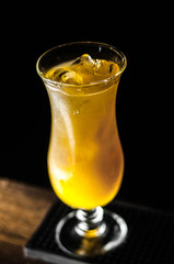 Yellow cocktail with in the extended glass