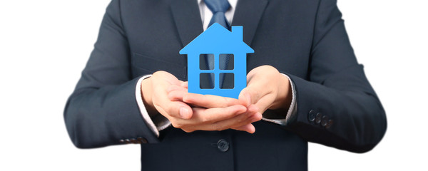 Mortgage concept by money house. holding  house model in hand