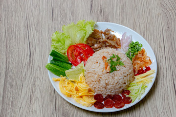 Rice Seasoned with Shrimp Paste or Khaao Khlook Gabpi in Transparent plastic lunch box. A simple and basic Thai food. Each of the dish’s components is separately prepared, set aside and mixed when eat