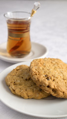 oatmeal cookies served with a glass of tea