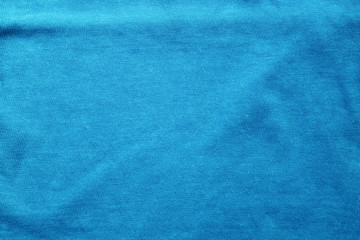 Fabric texture of wavy light blue cotton material background. Worn creasy shirt canvas, blue...