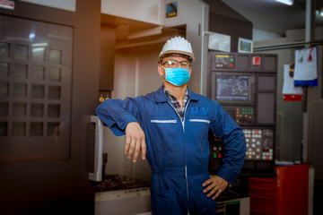 Portrait engineer under inspection and checking production process on factory station by wearing safety mask to protect for pollution and virus in factory.