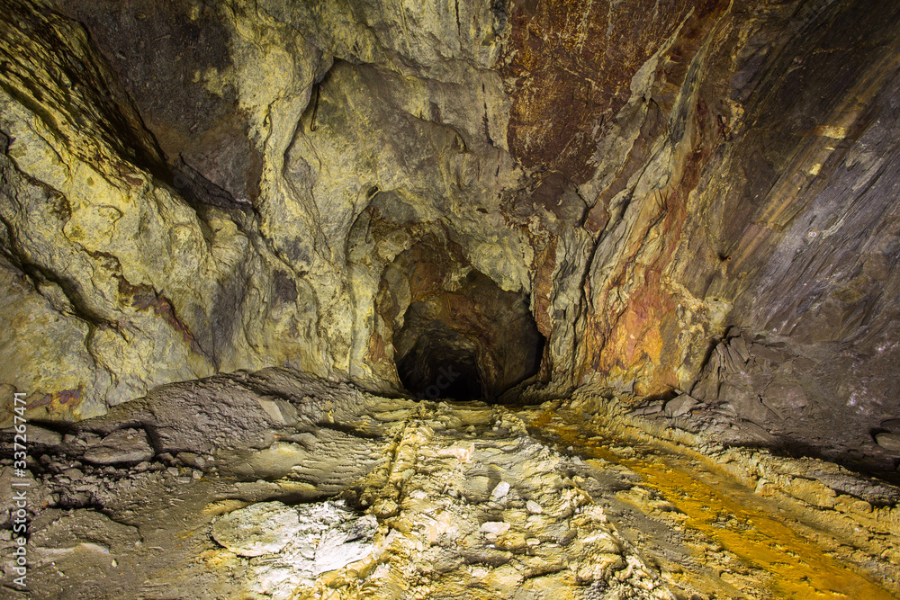 Wall mural abandoned copper ore mine underground tunnel with yellow dirt