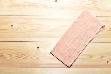 Pink napkin on a wooden background