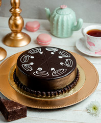 chocolate cake on a tray and a cup of fragrant tea