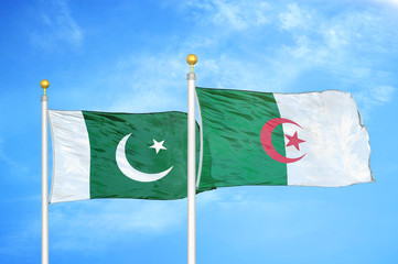 Pakistan and Algeria two flags on flagpoles and blue cloudy sky
