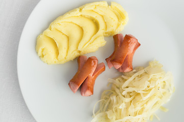 fried sausages with potato mash and stewed white cabbage