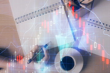 Multi exposure of woman's hands making notes with forex graph hologram. Concept of technical analysis.