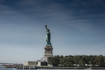 Ellis Island during clear day with Statue of Liberty