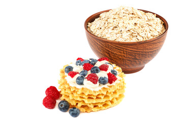 Fresh blueberries, raspberries, waffle cookies and oatmeal