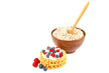 Fresh blueberries, raspberries, waffle cookies and oatmeal