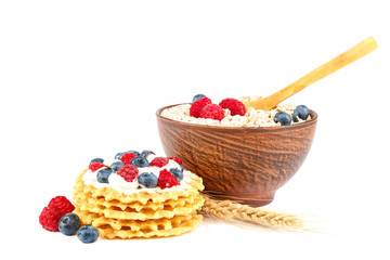 Fresh blueberries, raspberries, waffle cookies and oatmeal