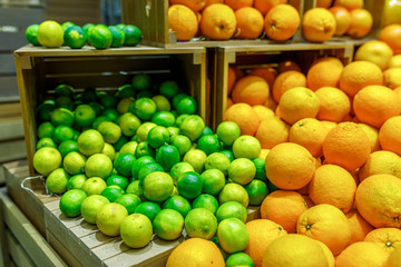 limes and oranges on the counter in the store