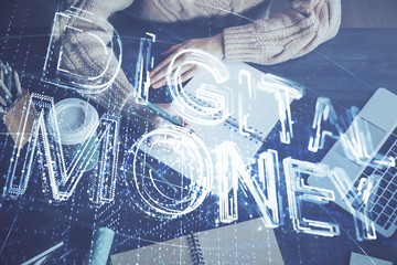 Cryptocurrency hologram over hands taking notes background. Concept of blockchain. Multi exposure