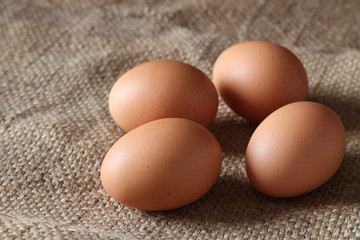 Fresh chicken eggs on burlap sack, concept for homemade organic food
