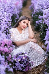 Portrait of beautiful romantic woman in fairy field of Margaret