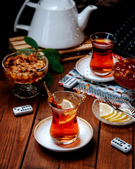 fresh black tea with lemon slice on the table