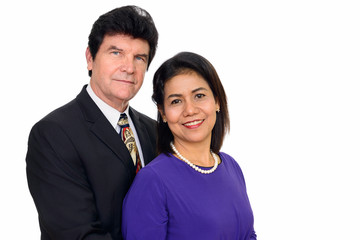 Studio shot of happy mature couple hugging isolated against white background