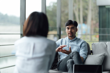 Two young Asian business men and women are working