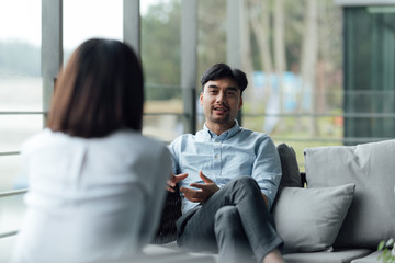 Two young Asian business men and women are working