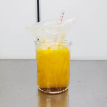 Close-up Of Yellow Drink In Glass On Table