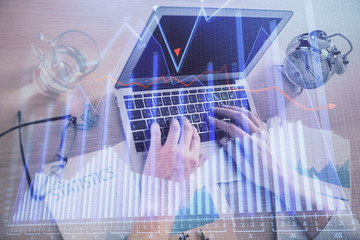Fototapeta premium Multi exposure of forex graph with man working on computer on background. Concept of market analysis.