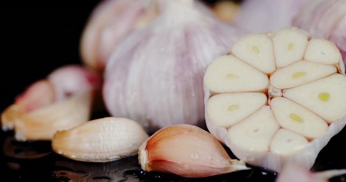 Cut fresh garlic falling water drops.