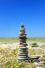 Rock balancing, stone stacks on the beach