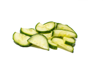 Slice of cucumber on white background. Cucumber whole and cut, being prepared for food.