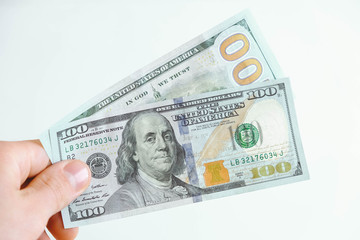 Two hundred dollar bills in hand on a white background. Copy, empty space for text