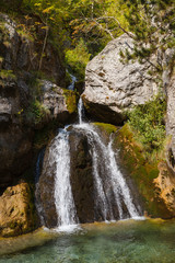 Enipeas waterfall with small lake surrounded by trees