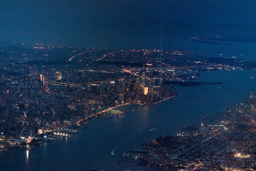 Fototapeta premium Nigh view of New York City from the air, plane
