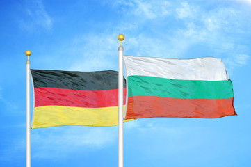 Germany and Bulgaria two flags on flagpoles and blue cloudy sky