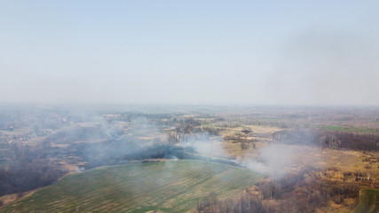 Forest and field fire. Dry grass burns, natural disaster. Aerial view. After the fire