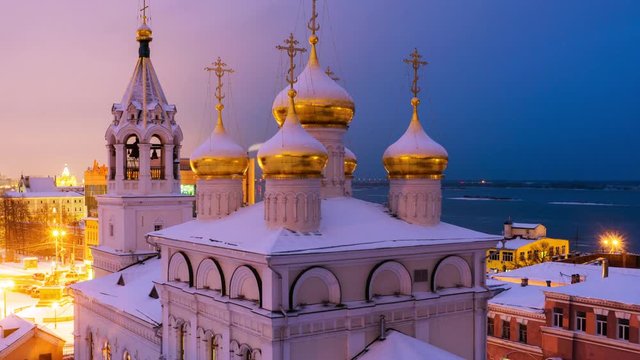 Nizhny Novgorod, Russia. Aerial view of Church of the Nativity of John the Precursor in Nizhny Novgorod, Russia at night in winter. Snow and colorful sunset sky. Time-lapse, panning video