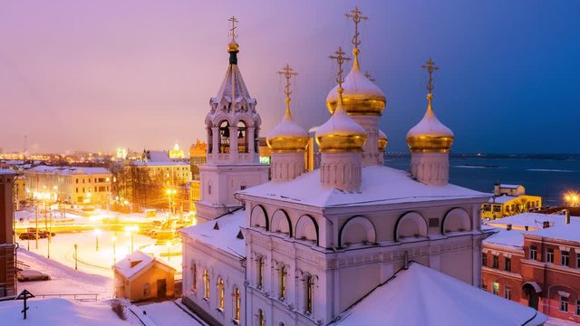 Nizhny Novgorod, Russia. Aerial view of Church of the Nativity of John the Precursor in Nizhny Novgorod, Russia at night in winter. Snow and colorful sunset sky. Time-lapse, zoom in