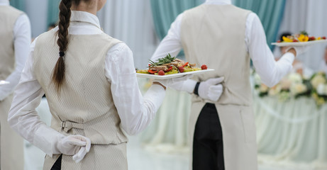 close up waiter holding a plate