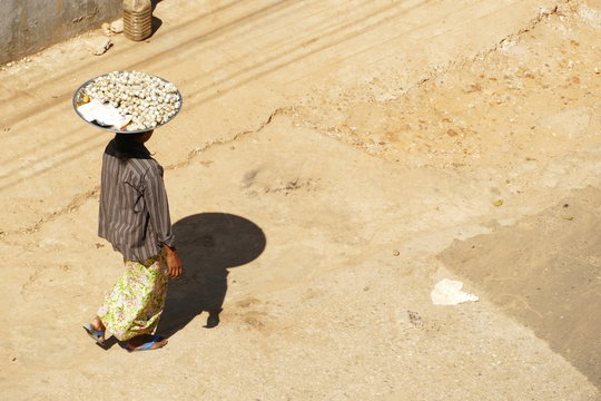 Walking woman in myanmar she bring food on her head 