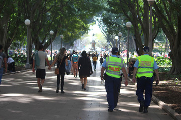 Procession of people including two police officers walking down a path in Hyde Park on their way to...