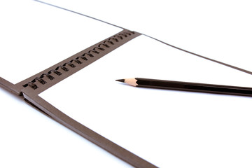 pencil and notebook on a white background