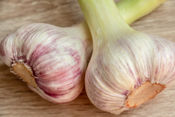 young garlic on a wooden background closeup