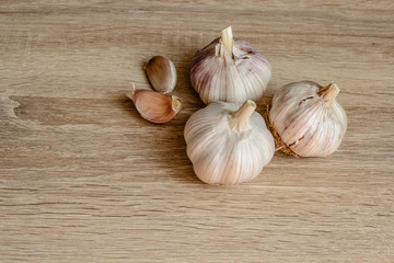 three garlics on a wooden background